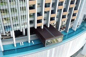 A modern high-rise building with multiple balconies and a rooftop pool area. - Lumi Tropicana by Livora Haus (Petaling Jaya)