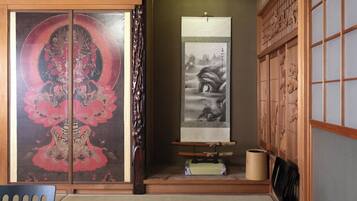 A traditional Japanese room with sliding doors, a tatami mat floor, and a shoji screen.