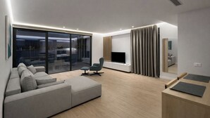 Ein modernes Wohnzimmer mit einer Couch, einem Fernseher und einem großen Fenster.