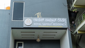 A building with a sign that reads "ROYAL SAMRAT RESIDENCY" and a logo with a crown and the text "Royal Samrat Residency". - The Royal Samrat Residency (karnataka)