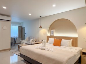 Une chambre d’hôtel moderne avec un grand lit, un bureau et une chaise.