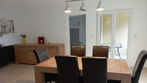 A dining area with a wooden table and four chairs, a cabinet, and pendant lights. - Escape to the Cévennes: house at the foot of Mont Cévenol, near Ardèche (Bessèges)