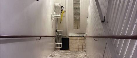 A staircase with white railings and a metal handrail.
