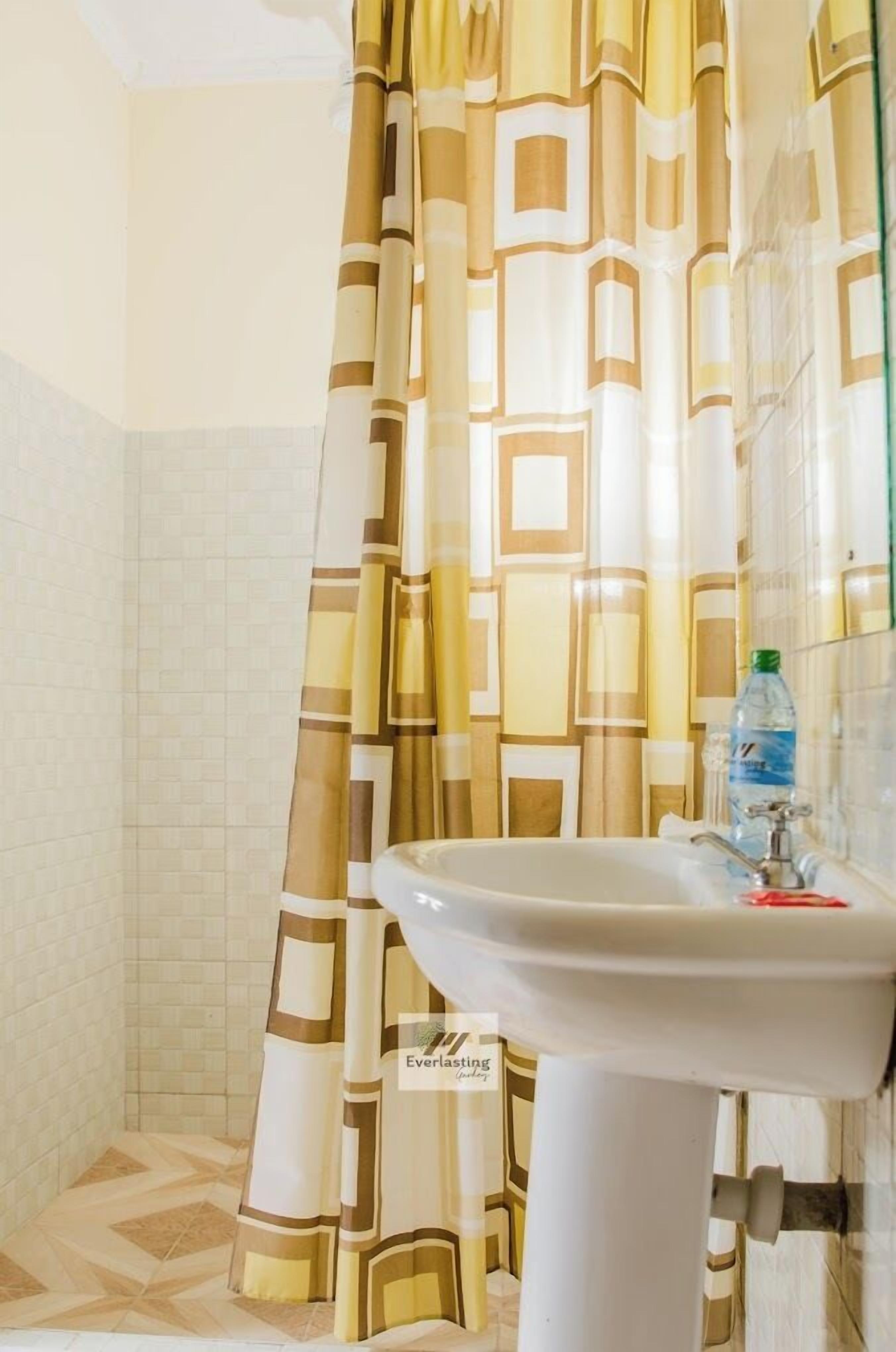 Chambre Deluxe avec lits jumeaux | Salle de bain | Douche, articles de toilette (gratuits), pantoufles, serviettes fournies