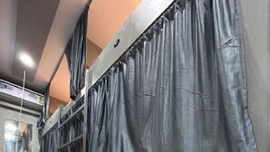 A row of lockers with a metal railing and a tiled floor. - Merhaba Hostel And PG (Mumbai)