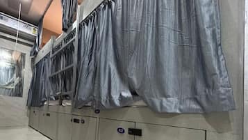 A row of lockers with a metallic finish and a tiled floor.