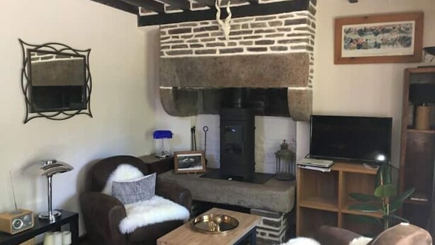 A cozy living room with a fireplace, a television, and a comfortable seating area.