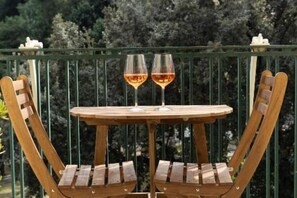 A wooden outdoor table with two wine glasses on a balcony railing. - Deluxe Room with Balcony City View - Sofia and the City of Wonders (Napoli)