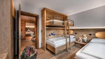A modern bedroom with a bunk bed, a desk, and a chair.