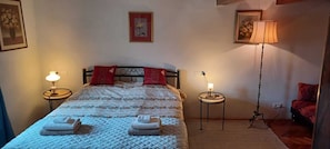 A neatly made bed with a quilt, two pillows, two bedside lamps, and two folded towels. - Royal Balcony al Mare (Rovinj)