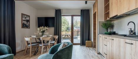 A modern kitchen with wooden cabinets and a dining area with a table and chairs.