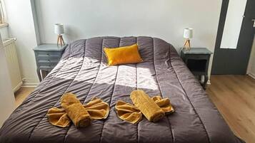 Una camera da letto moderna con un letto grande, un quadro astratto dai colori vivaci e un velux.
