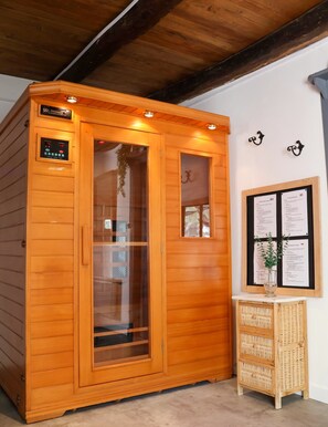 A sauna with a digital control panel, a glass door, and a wooden interior. - Gîte Les Racines de Lili with Private Pool, Terrace, and Wi-Fi in Cieurac (Cieurac)