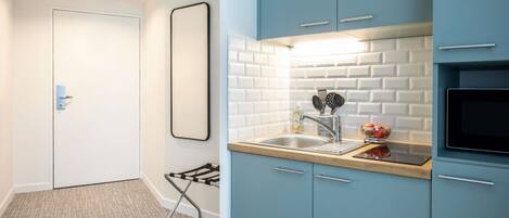 A modern kitchen with a built-in sink, a microwave, and a toaster.