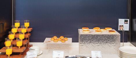 A breakfast buffet with various food items and drinks.