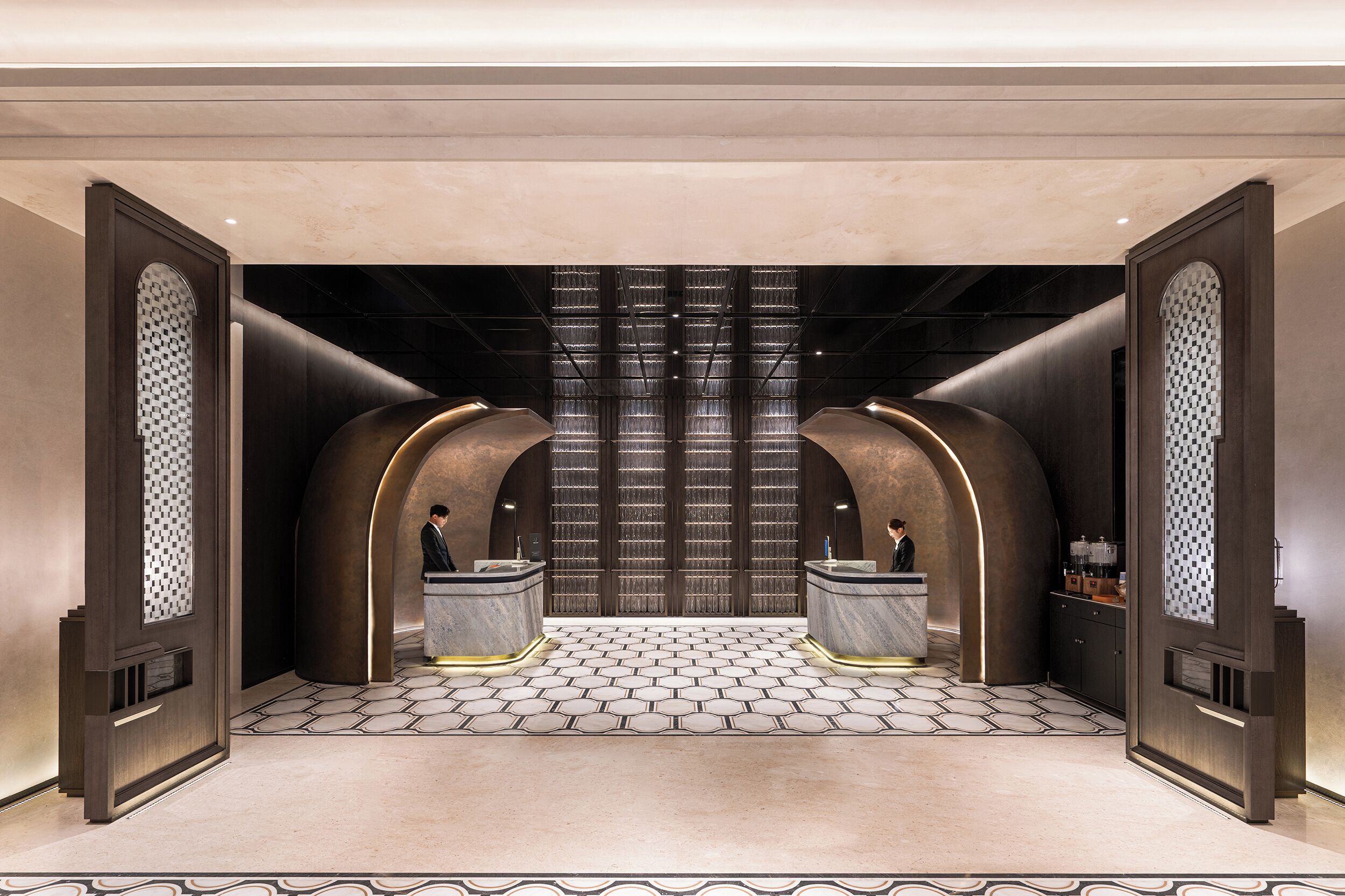 A modern bathroom with a checkered floor, two sinks, and a large mirror.