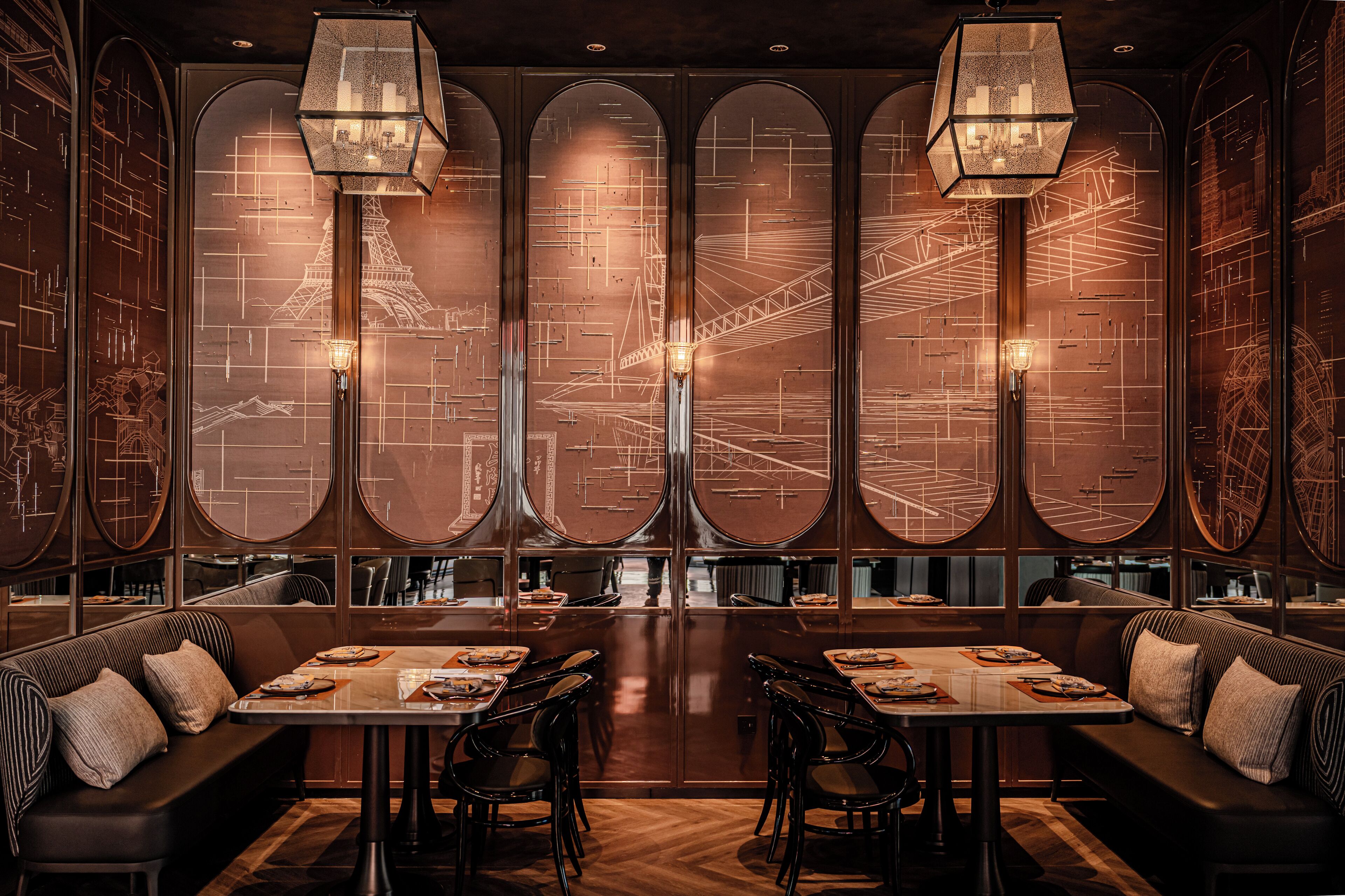 A restaurant with a long counter, booths, and a large window with a cityscape view.