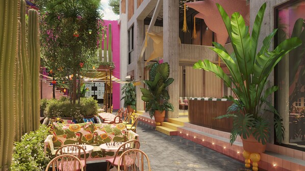 Un patio con una mesa de ajedrez, plantas en macetas y una escalera.