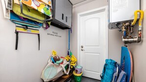A storage area with various bags, toys, and a sign instructing to put away used items. - Walk To Ponto Beach - Surf and Relax (Carlsbad)