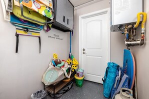 A storage area with various bags, toys, and a sign instructing to put away used items. - Walk To Ponto Beach - Surf and Relax (Carlsbad)
