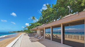 A beachside resort with a covered seating area overlooking the ocean, palm trees, and a clear blue sky. - Walk to Beach | Beach Cabana | AC | Eldorado B102 | Ground Floor | New 1 BR (Ka'anapali)