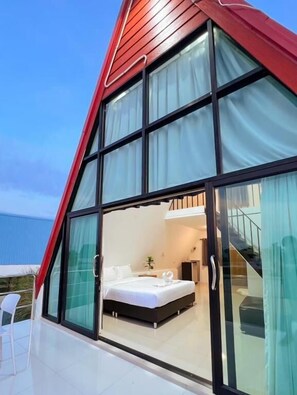 Une chambre moderne avec un grand lit, une petite table de chevet et une fenêtre avec des rideaux.