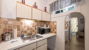 Fridge, microwave, coffee/tea maker, cookware/dishes/utensils