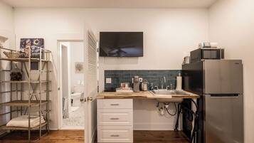 Fridge, microwave, coffee/tea maker, cookware/dishes/utensils