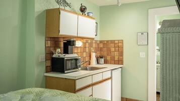 Fridge, microwave, coffee/tea maker, cookware/dishes/utensils