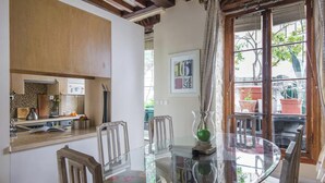A dining area with a glass table, chairs, and a view of the outdoors. - A PERFECT BASE FOR EXPLORING PARIS & ENJOYING AN AUTHENTIC LEFT BANK EXPERIENCE. (Paris)