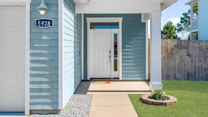 Een gelijkvloers huis met een garage, een voordeur en een brievenbus.