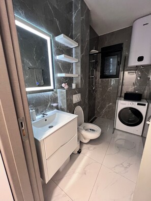 Regadera, secadora de cabello, toallas, papel de baño 