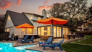 A backyard with a swimming pool, lounge chairs, and a barbecue area. - Resort Oasis w/ Pool | Hot Tub | Mini Golf & Games (San Antonio)