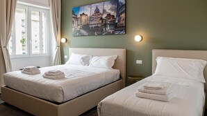 A hotel room with two beds, a large window, and a cityscape painting on the wall. - Flora Guest House (Rome)