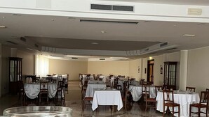 A spacious dining area with multiple tables set for guests, a polished tiled floor, and a ceiling with recessed lighting. - Naples Park Hotel (Marigliano)