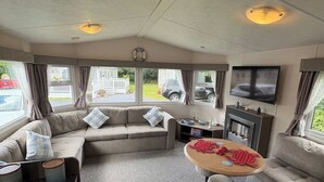 Ein gemütliches Wohnzimmer mit einer Couch, einem runden Tisch und einem Kamin.