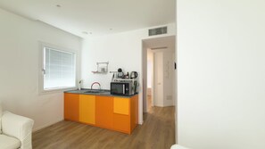 A compact kitchen with a built-in microwave, kettle, and small sink. - Villa Ada-Luna - One Bedroom Apartment, Sleeps 2 (Olbia)
