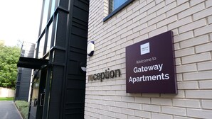 A sign welcoming to Gateway Apartments with a reception area. - Student Only Gateway Apartments (Edinburgh)