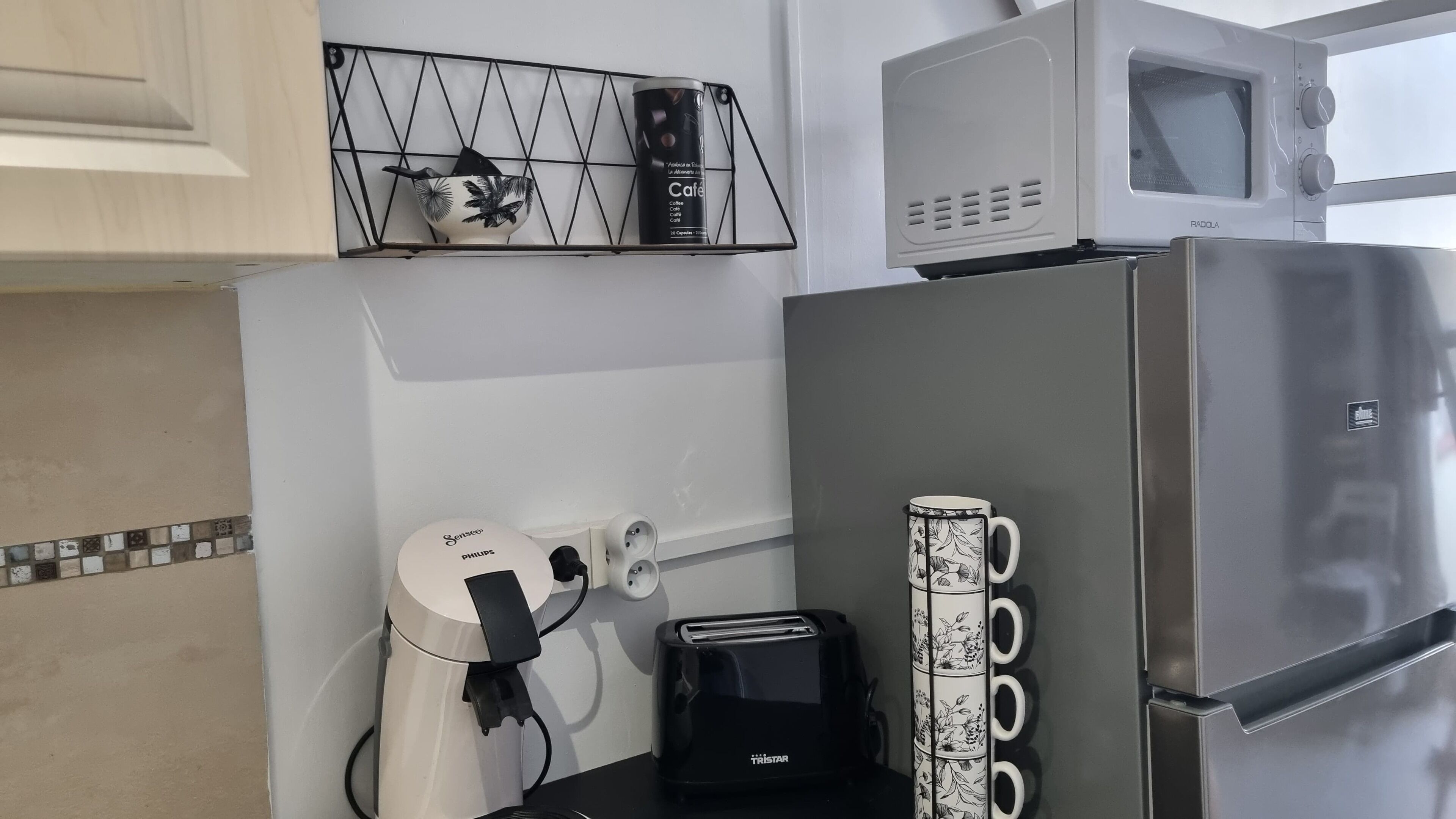 A kitchenette with a microwave, toaster, and coffee maker.