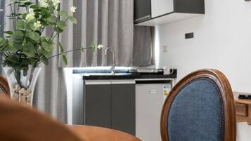 A modern kitchen with a built-in dishwasher, a sink, and a cabinet above the counter.