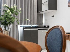 A modern kitchen with a built-in dishwasher, a sink, and a cabinet above the counter. - Sama Al Hamra Furnished Apartments (Beirut)