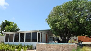 A house with a swimming pool, a large tree, and a barbecue area. - Blu-Entire waterfront house (Christiansted)