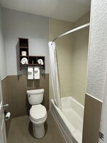 Standard Single Room, 1 King Bed | Bathroom | Bathtub, towels, soap, shampoo