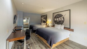 A hotel room with two beds, a desk, a chair, a TV, and a NASA-themed wall decoration. - Azul Inn Houston Hobby Airport (Houston)