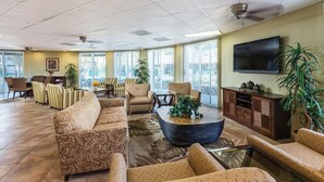 A spacious lobby with a sofa, armchairs, a coffee table, and a TV. - Palm Springs | Relaxing Desert Escape | Pool + Hot Tub (Palm Springs)