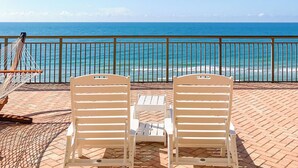 Two white lounge chairs facing a beach with a clear view of the ocean. - St. John's Inn (Myrtle Beach)