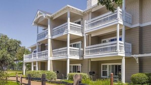 A multi-story residential building with balconies, a paved driveway, and surrounding greenery. - Sonoma | Vineyard Getaway & Outdoors | Pool | 2BR Twin (Windsor)