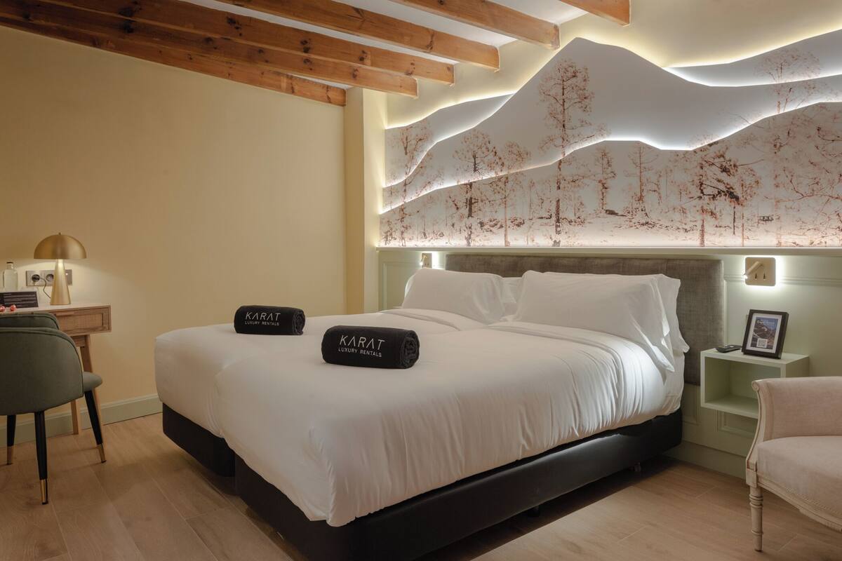 Un dormitorio moderno con una cama grande, un escritorio y una silla.
