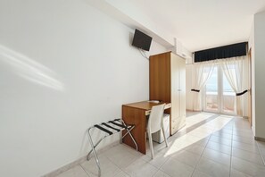 A room with a desk, chair, and a television mounted on the wall. - Bright B&B with Sea View Balcony - 102 - Santangelo - Pool (Monte Sant'Angelo)