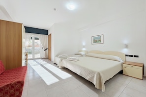 Une chambre d’hôtel avec un lit, une table de chevet, une chaise et une vue sur l’extérieur.